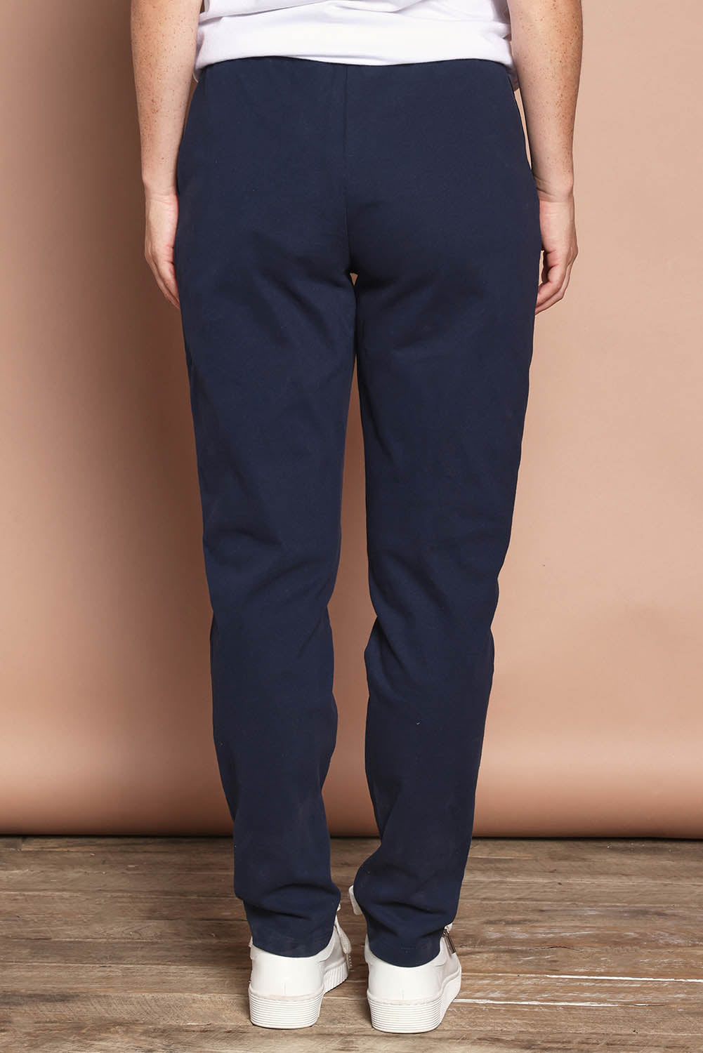 Model Katie wearing size 8 of the Elements Monday Cotton Pant in colour Navy (Blue), from the back