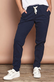 Model Katie wearing size 8 of the Elements Monday Cotton Pant in colour Navy (Blue), from the front, cropped image