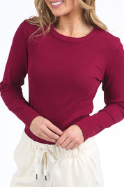 A model wearing the Elements Scoop Rib Cotton Blend  Long Sleeve in colour Beetroot (Red), from the front, cropped image