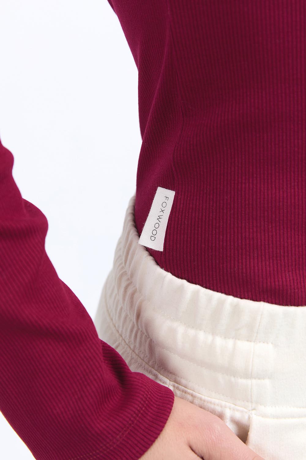 A model wearing the Elements Scoop Rib Cotton Blend  Long Sleeve in colour Beetroot (Red), from the front, cropped image