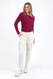 A model wearing the Elements Scoop Rib Cotton Blend  Long Sleeve in colour Beetroot (Red), from the front, showing the whole outfit