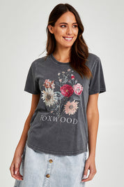 Model Madeline wearing size 10 of the Bouquet Tee in colour Black (Black), from the front, cropped image