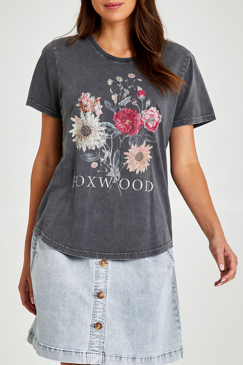 Model Madeline wearing size 10 of the Bouquet Tee in colour Black (Black), from the front, cropped image