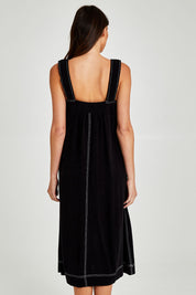 Model Madeline wearing size 10 of the Sage Dress in colour Black (Black), from the back
