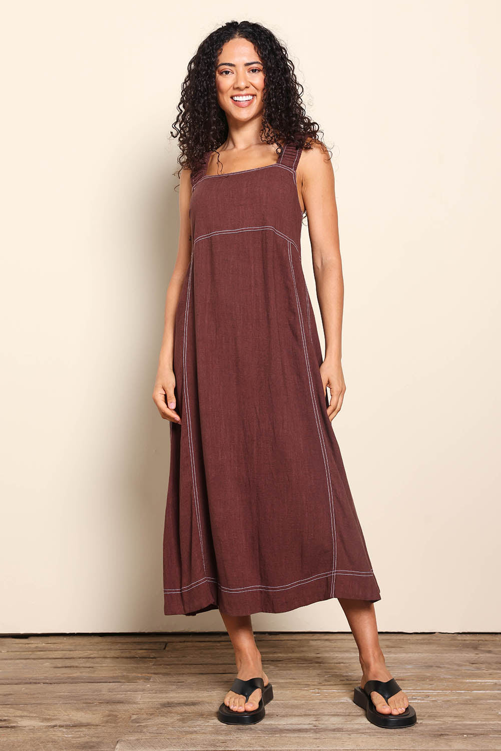Model Pamelar wearing size 10 of the Sage Dress – Chocolate in colour Chocolate, from the front