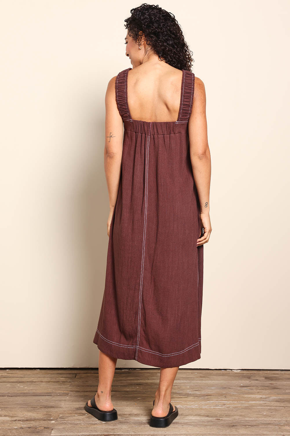 Model Pamelar wearing size 10 of the Sage Dress – Chocolate in colour Chocolate, from the front