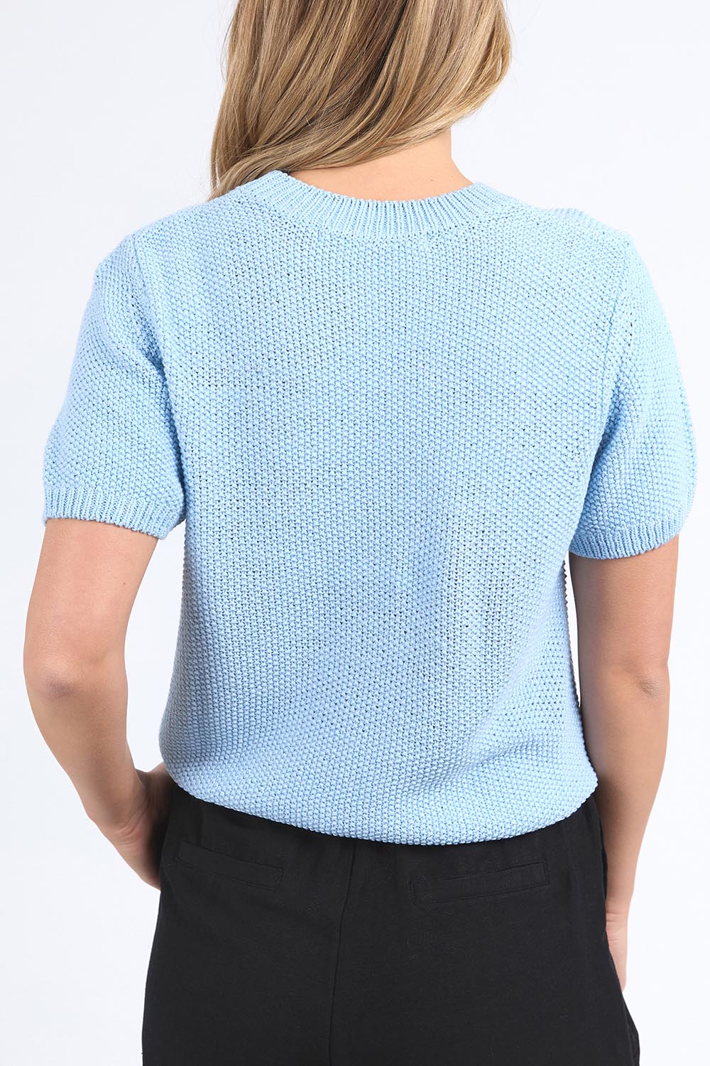 A model wearing the Blair Short Sleeve Cotton Knit in colour Cascadeblu (Blue), from the back