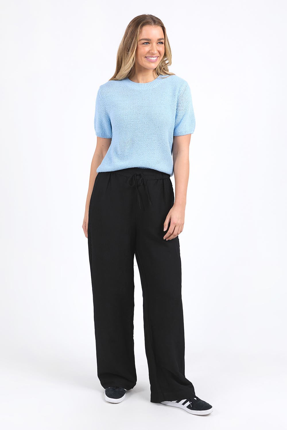 A model wearing the Blair Short Sleeve Cotton Knit in colour Cascadeblu (Blue), from the front, showing the whole outfit
