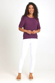Model Pamelar wearing size 10 of the Blair Short Sleeve Knit – Plum in colour Plum, from the front