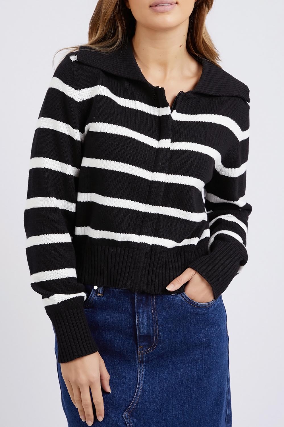 A model wearing the Effie Polo Knit in colour Blackwhite (Black), from the front, cropped image