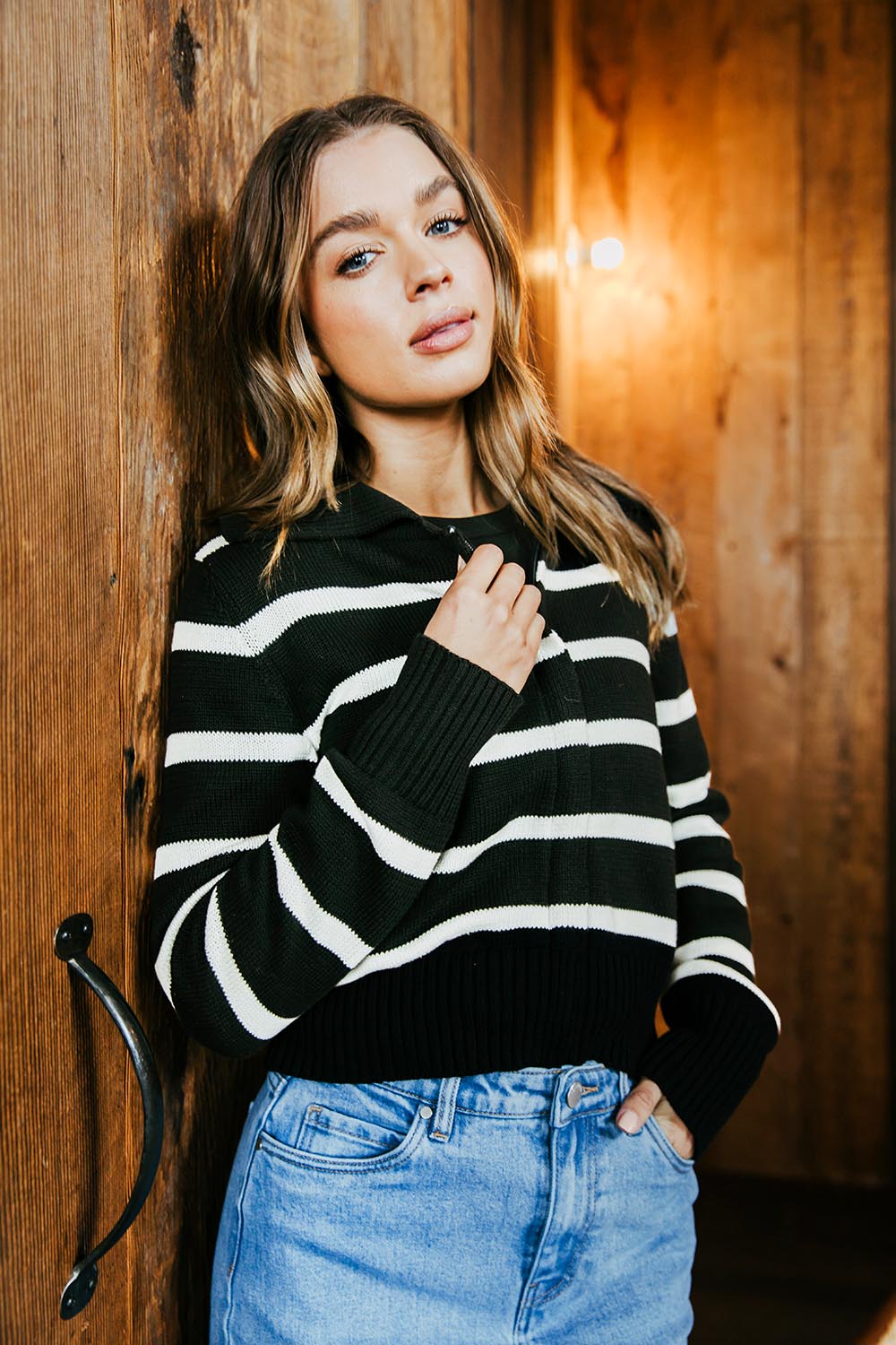 A model wearing the Effie Polo Knit in colour Blackwhite (Black), from the front, showing the whole outfit