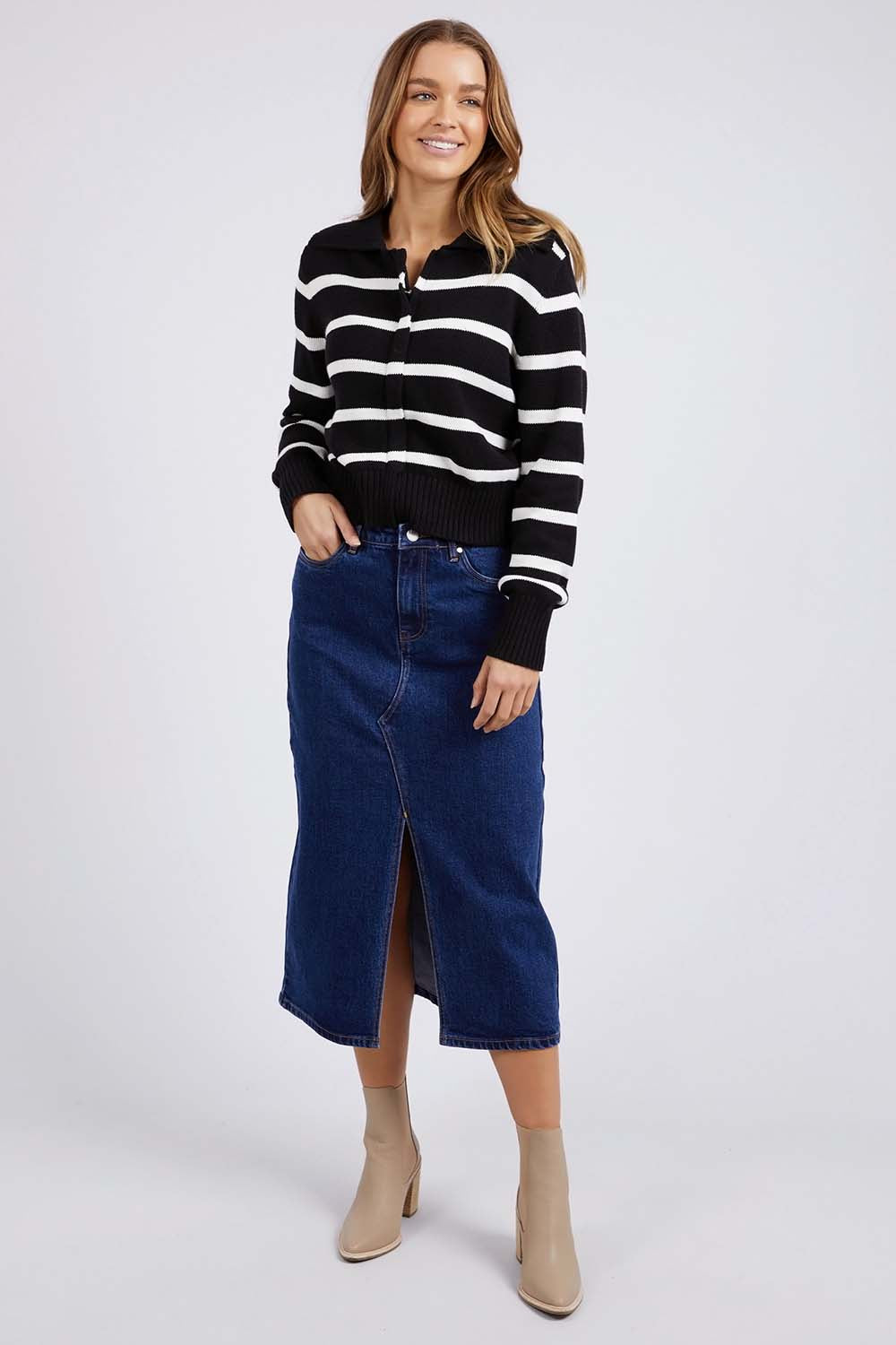 A model wearing the Effie Polo Knit in colour Blackwhite (Black), from the front, showing the whole outfit