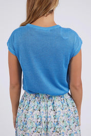 A model wearing the Alma Metallic Knit in colour Azureblue (Blue), from the back
