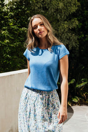 A model wearing the Alma Metallic Knit in colour Azureblue (Blue), from the front, showing the whole outfit