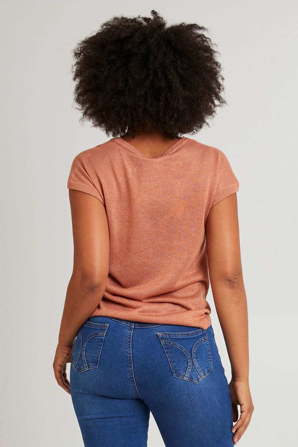 Model Olivia wearing size 10 of the Alma Metallic Knit in colour Clay, from the back