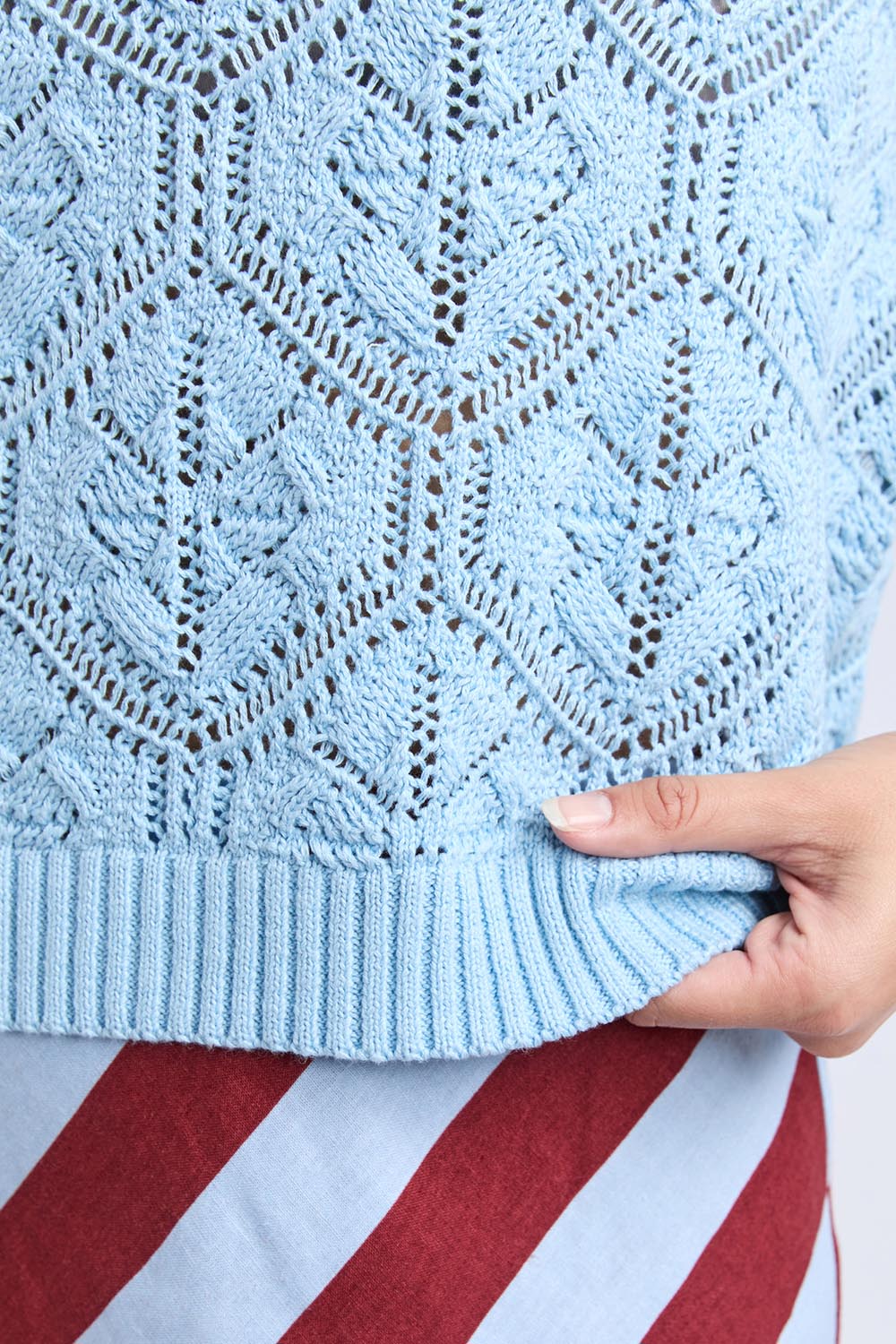 A model wearing the Luna Cotton Knit Vest in colour Cerulean (Blue), from the front, cropped image