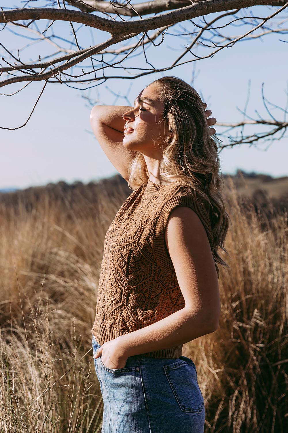 A model wearing the Luna Cotton Knit Vest in colour Toastcocon, from the front, showing the whole outfit