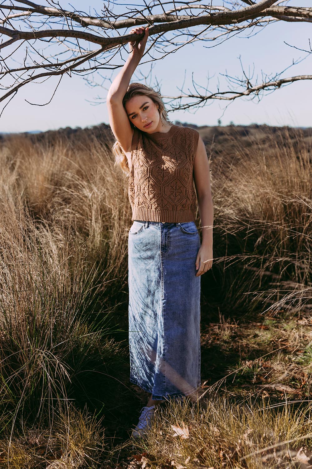 A model wearing the Luna Cotton Knit Vest in colour Toastcocon, from the front, showing the whole outfit