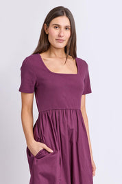 Model Genericm wearing size sample of the Ella Dress – Plum in colour Plum, in a cropped view
