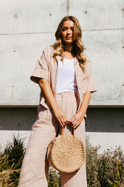 A model wearing the Maya Geo Shirt in colour Mayageo, from the front, showing the whole outfit