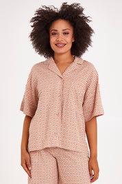 Model Olivia wearing size 10 of the Maya Geo Shirt in colour Mayageo, from the front, cropped image