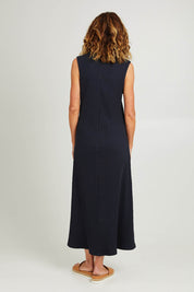 Model Emma wearing size 10 of the Pippa Rib Dress in colour Navy (Blue), from the back
