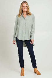 Model Grace wearing size 10 of the Sorrento Shirt in colour Sagegreen (Green), from the front, showing the whole outfit