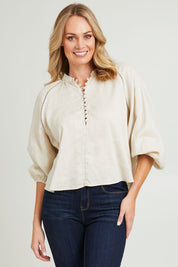 Model Grace wearing size 10 of the Sardina Blouse in colour Bone, from the front, cropped image