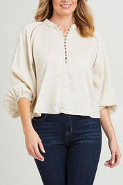Model Grace wearing size 10 of the Sardina Blouse in colour Bone, from the front, cropped image