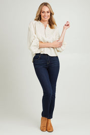 Model Grace wearing size 10 of the Sardina Blouse in colour Bone, from the front, showing the whole outfit