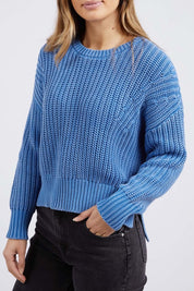 A model wearing the Winnie Knit Crew in colour Dukeblue (Blue), from the front, cropped image
