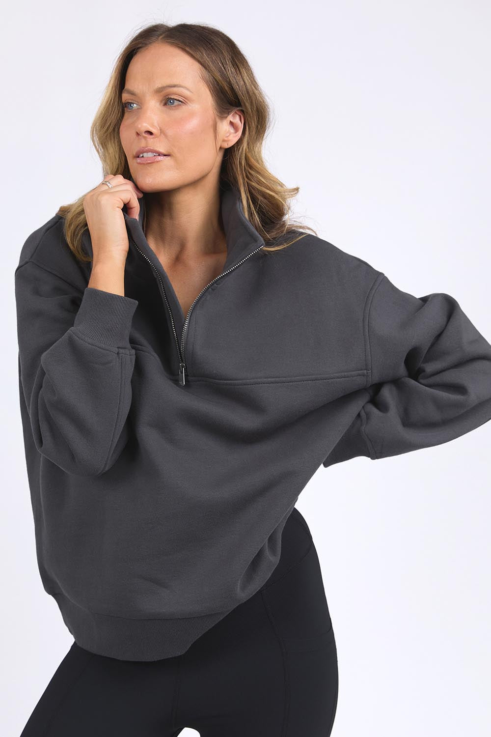 A model wearing the Elements College Zip Crew in colour Coal (Grey), from the front, cropped image
