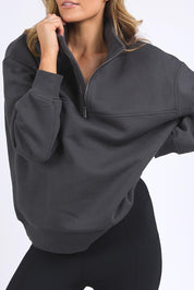 A model wearing the Elements College Zip Crew in colour Coal (Grey), from the front, cropped image