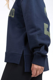 A model wearing the Interval Cotton Crew in colour Navy (Blue), from the front, cropped image
