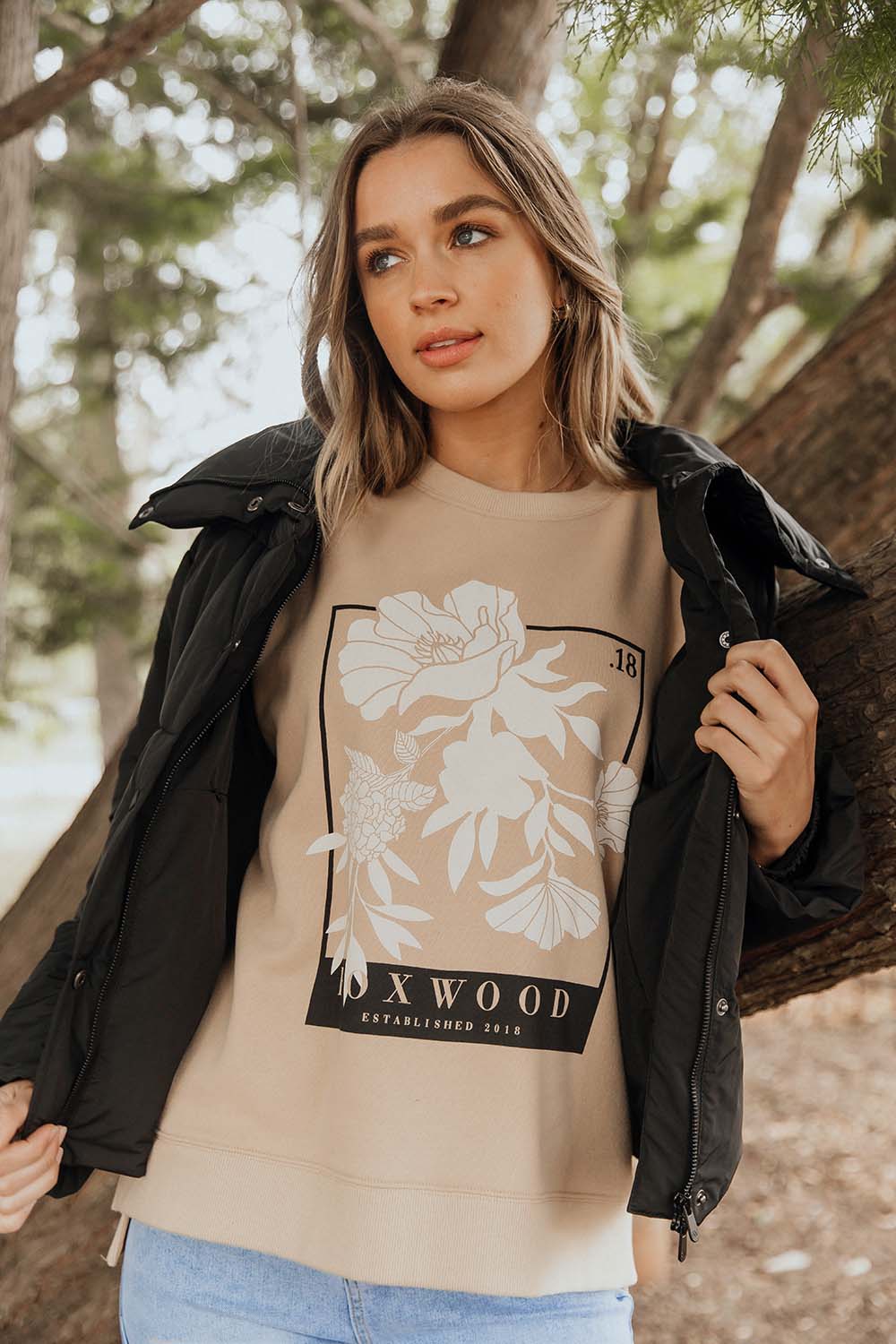 A model wearing the Carnation Crew in colour Sesame, from the front, showing the whole outfit