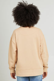 Model Olivia wearing size 10 of the Carnation Crew in colour Sesame, from the back