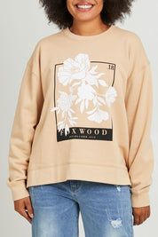 Model Olivia wearing size 10 of the Carnation Crew in colour Sesame, from the front, cropped image