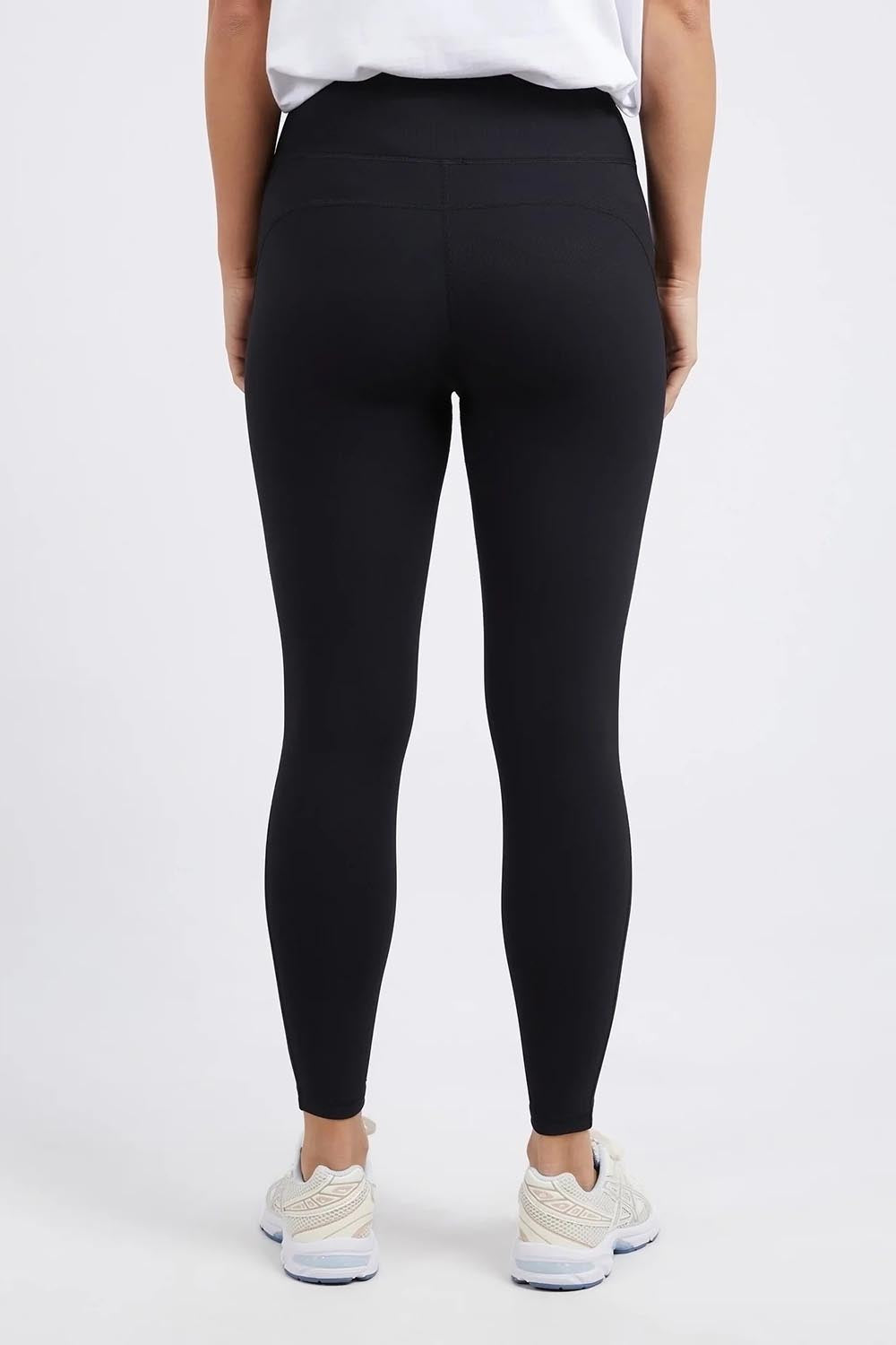 A model wearing the Leisure Luxe Rib Legging in colour Black (Black), from the back