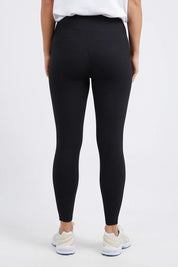A model wearing the Leisure Luxe Rib Legging in colour Black (Black), from the back