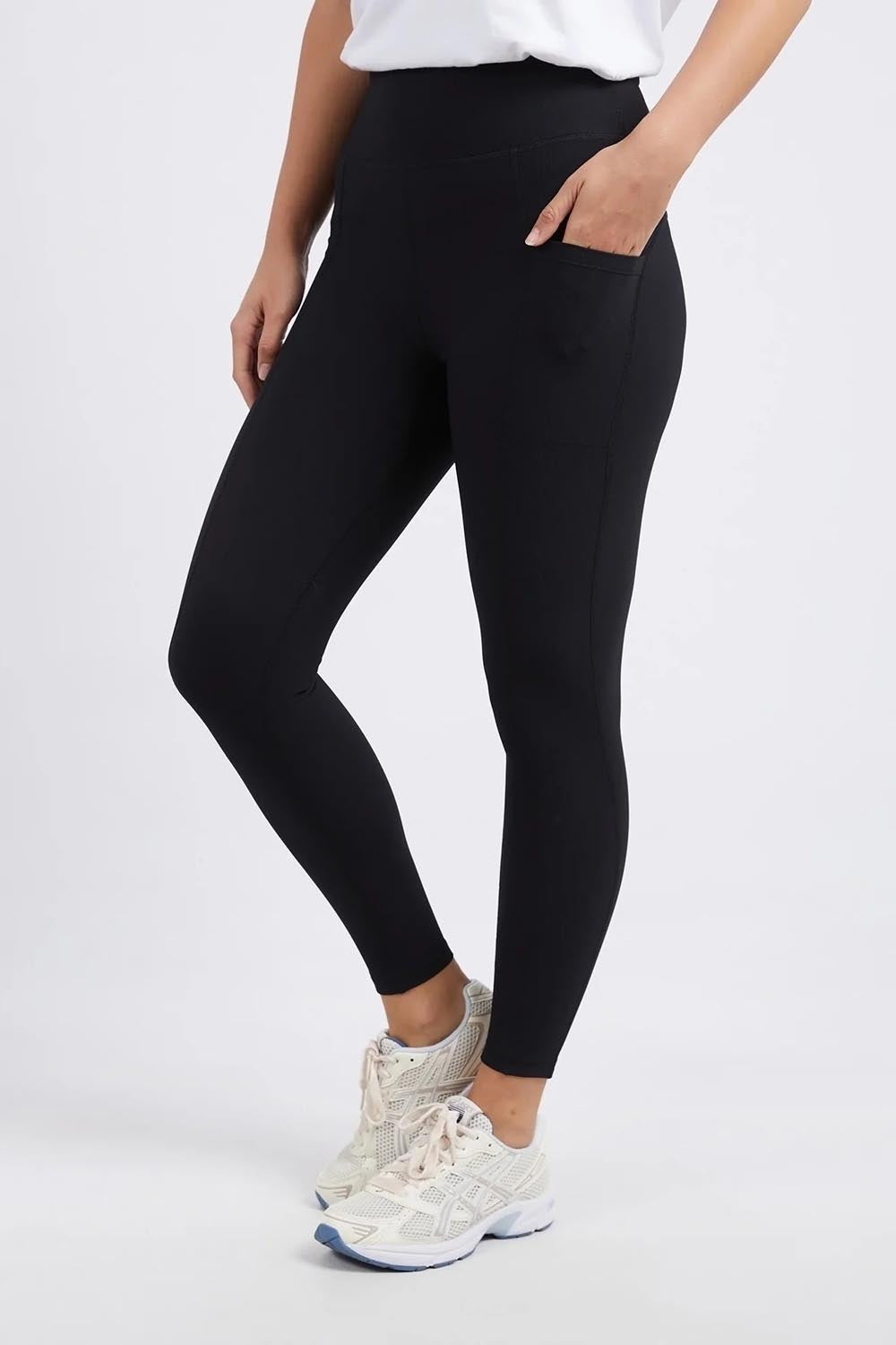 A model wearing the Leisure Luxe Rib Legging in colour Black (Black), from the front, cropped image