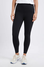 A model wearing the Leisure Luxe Rib Legging in colour Black (Black), from the front, cropped image