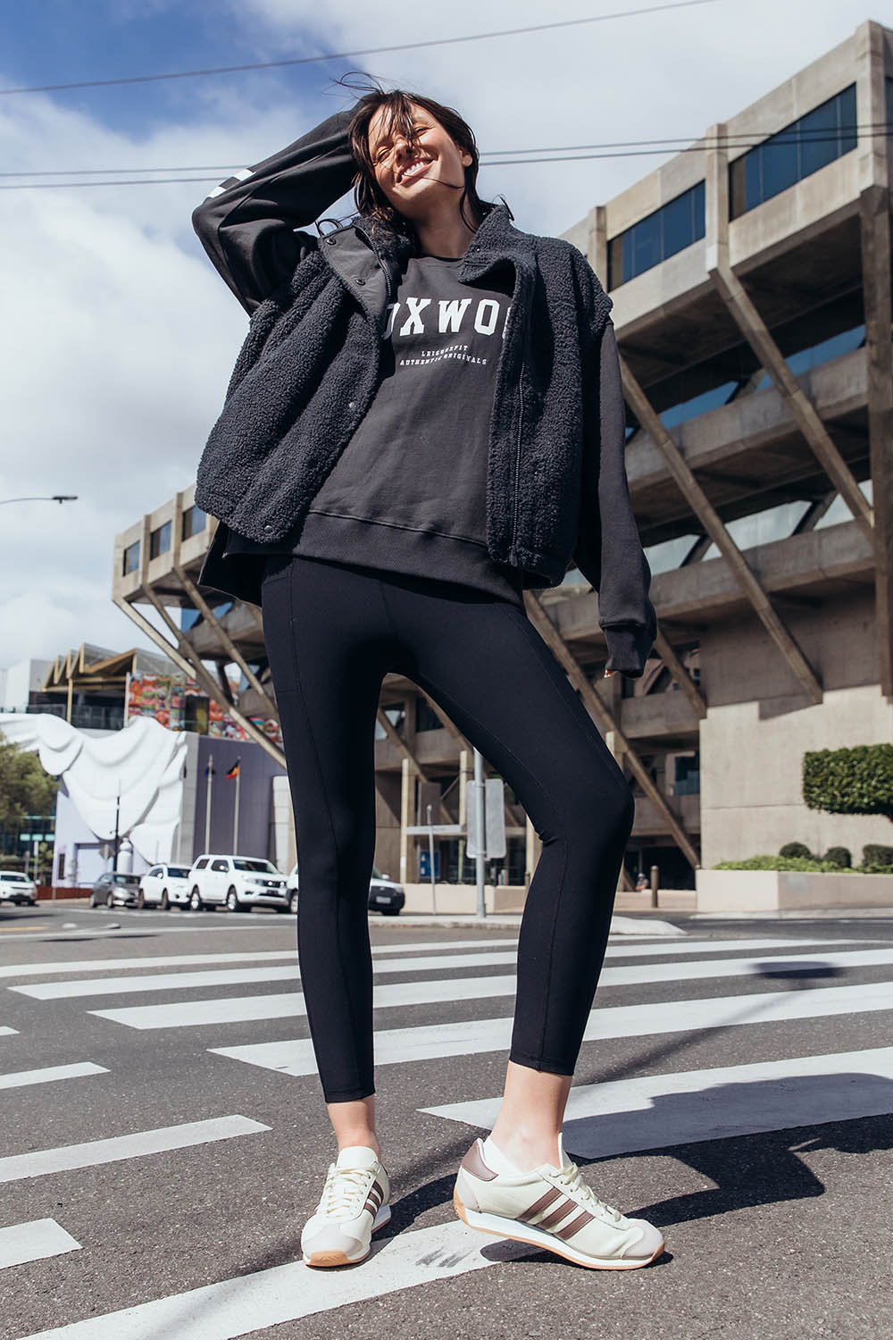 A model wearing the Leisure Luxe Rib Legging in colour Black (Black), from the front, showing the whole outfit
