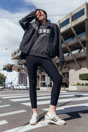 A model wearing the Leisure Luxe Rib Legging in colour Black (Black), from the front, showing the whole outfit