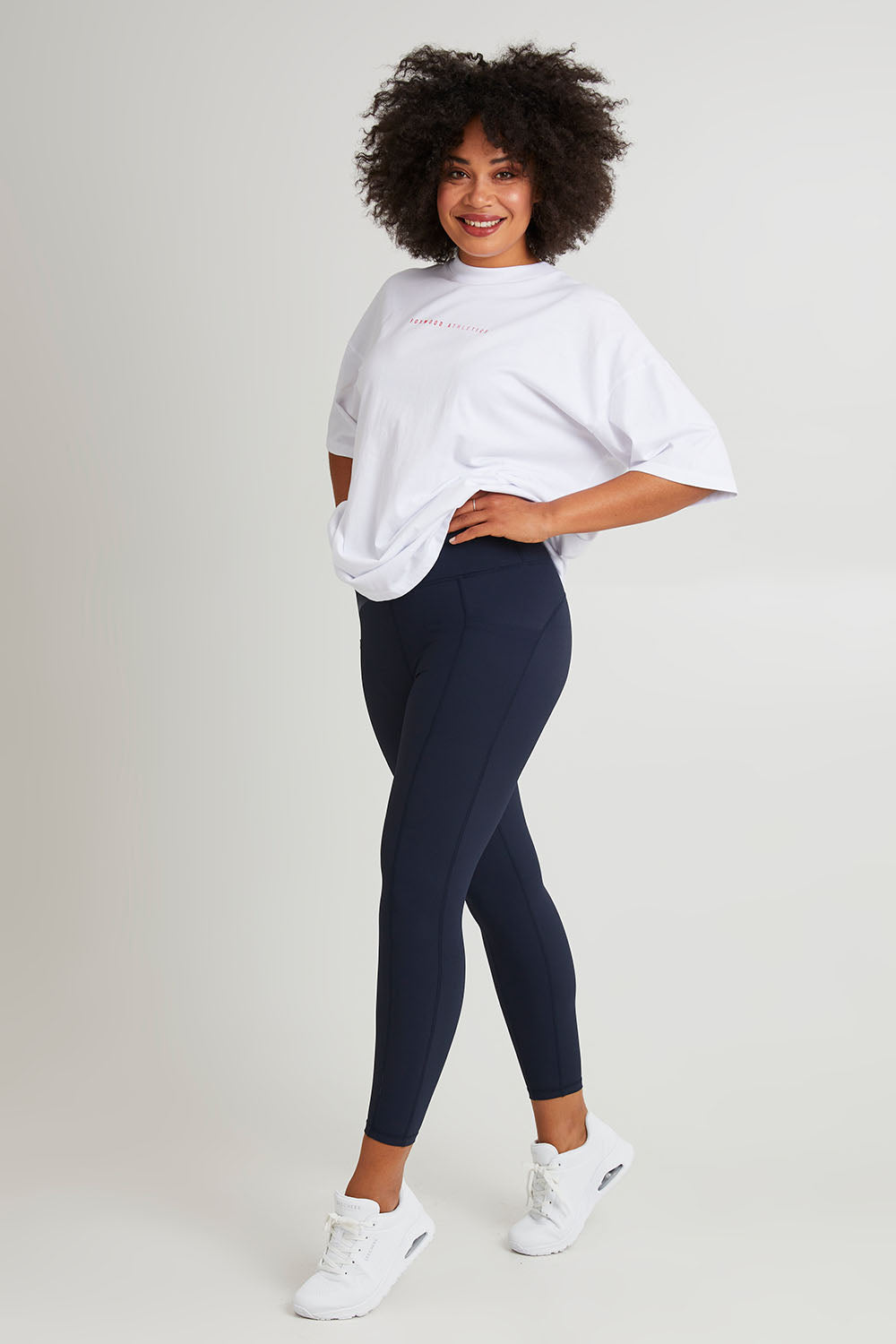 Model Olivia wearing size 10 of the Leisure Luxe Rib Legging in colour Navy (Blue), from the front, showing the whole outfit