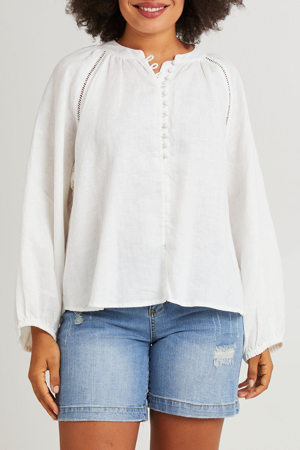 Model Olivia wearing size 10 of the Corsica Blouse in colour Vinwhite (White), from the front, cropped image