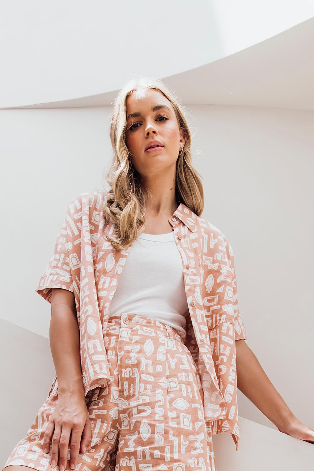 A model wearing the Etched Geo Shirt in colour Clay, from the front, showing the whole outfit