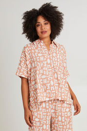 Model Olivia wearing size 10 of the Etched Geo Shirt in colour Clay, from the front, cropped image