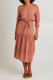 Model Olivia wearing size 10 of Thea Dress in colour Clay, from the front, cropped image