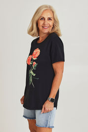 Model Sandy wearing size 10 of the Bloom Tee in colour Wshdblk (Black), from the front, cropped image