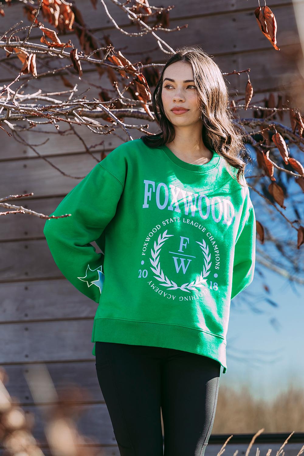 A model wearing the State League Cotton Crew in colour Green (Green), from the front, showing the whole outfit